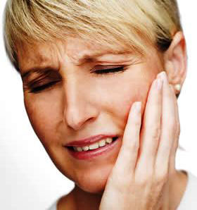 Woman holding her jaw in pain